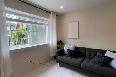 a living room with a couch and a window at Modern Spacious 1BR minutes away from Main St in Vancouver