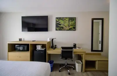 a room with a desk with a computer and a bed at Baymont by Wyndham Gold River in Gold River