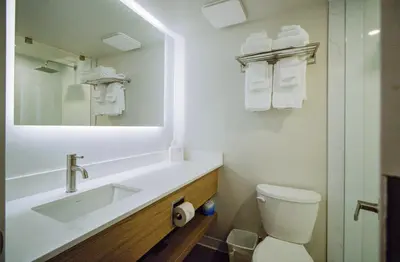 a bathroom with a sink and a toilet and a mirror at Baymont by Wyndham Gold River in Gold River