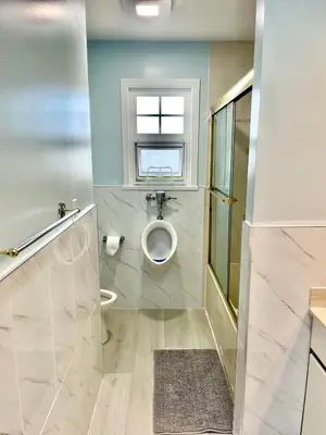 a bathroom with a toilet and a window at Rose Garden Vancouver Airport - Richmond BC in Richmond