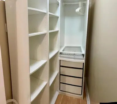 a walk in closet with white shelves at Rose Garden Vancouver Airport - Richmond BC in Richmond