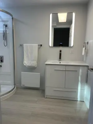 a bathroom with a sink and a mirror at Rose Garden Vancouver Airport - Richmond BC in Richmond