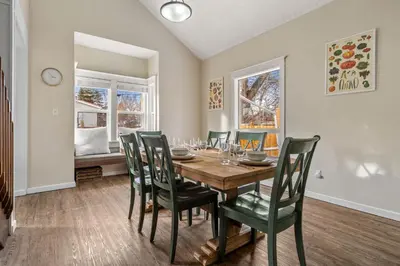 a dining room with a wooden table and chairs at Dinos Last Post - Family Friendly 4 Bedrooms in Drumheller