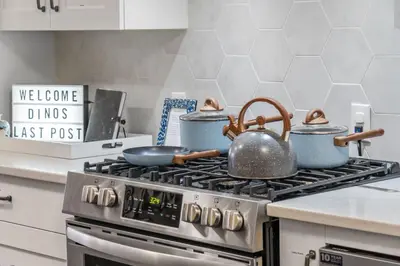 a stove with pots and pans on top of it at Dinos Last Post - Family Friendly 4 Bedrooms in Drumheller