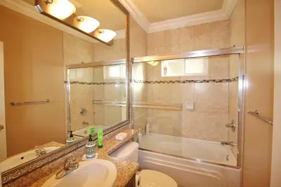 a bathroom with a sink and a shower and a toilet at Close to YVR King Sized Private Entrance Suite in Richmond
