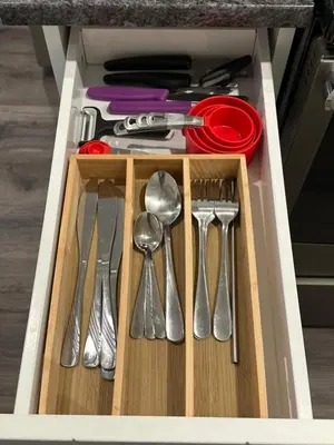 a drawer with silver utensils in a kitchen at Juanus Cozy Cove in Edmonton