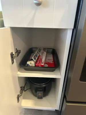 a drawer in a cabinet with a tray of food at Juanus Cozy Cove in Edmonton