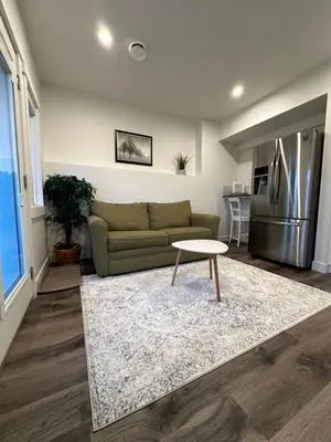 a living room with a couch and a table at Juanus Cozy Cove in Edmonton