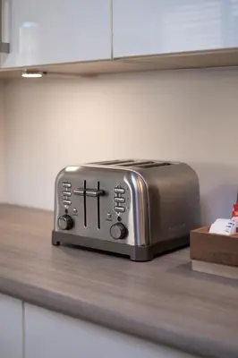 a toaster sitting on top of a kitchen counter at 3BR Near Commercial Dr 10 min to Downtown in Vancouver