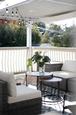 a patio with two chairs and a table with a plant at 3BR Near Commercial Dr 10 min to Downtown in Vancouver