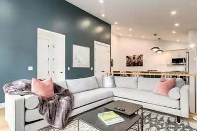 a living room with a couch and a table at Long Stays, Pets Welcome, Free Parking & King Bed in Calgary