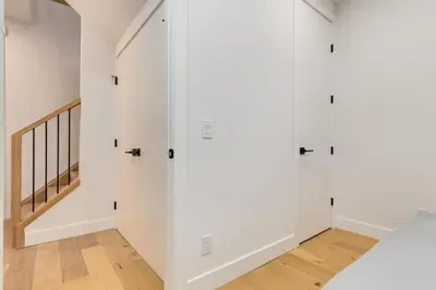 a room with white walls and a stairway at Long Stays, Pets Welcome, Free Parking & King Bed in Calgary