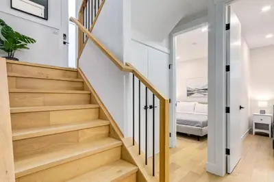 a hallway with stairs leading to a bedroom at Long Stays, Pets Welcome, Free Parking & King Bed in Calgary