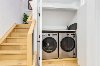 a laundry room with a washer and dryer at Long Stays, Pets Welcome, Free Parking & King Bed in Calgary