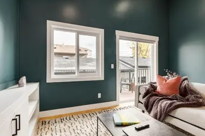 a living room with green walls and a couch at Long Stays, Pets Welcome, Free Parking & King Bed in Calgary