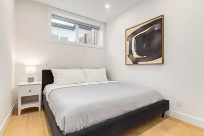 a bedroom with a bed and a picture on the wall at Long Stays, Pets Welcome, Free Parking & King Bed in Calgary