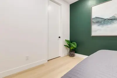 a bedroom with a bed and a green wall at Free Parking, Perfect Family Home with King Bed in Calgary