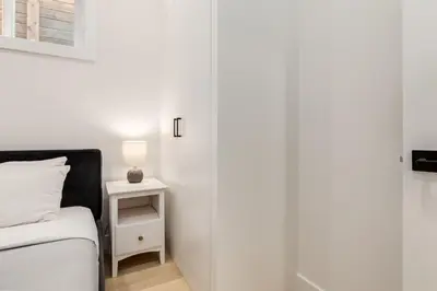 a bedroom with a bed and a lamp on a night stand at Free Parking, Perfect Family Home with King Bed in Calgary