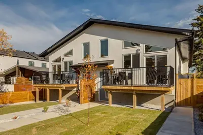 a house with a balcony and a yard at Free Parking, Perfect Family Home with King Bed in Calgary