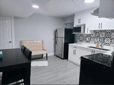 a kitchen with a refrigerator and a counter top at A new luxury basement apartment in Surrey