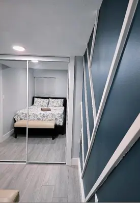 a bedroom with a bed and a glass wall at A new luxury basement apartment in Surrey