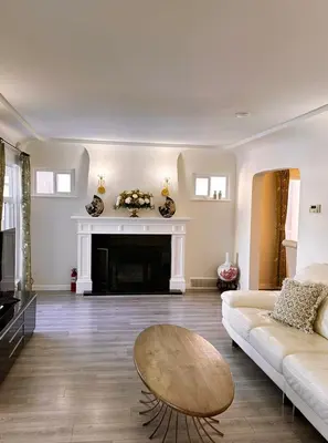 a living room with a couch and a fireplace at Elmshade Villa in Vancouver South in Vancouver