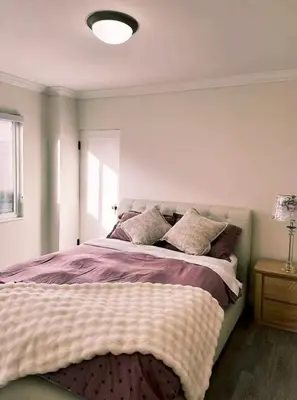 a bedroom with a large bed with pillows on it at Elmshade Villa in Vancouver South in Vancouver