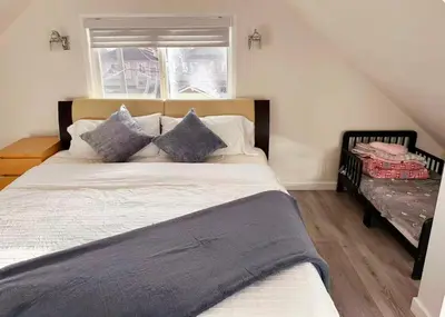 a bedroom with a large bed and a window at Elmshade Villa in Vancouver South in Vancouver