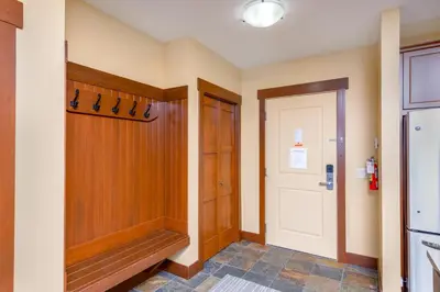 a hallway with a walk in closet and a door at Stonegate Resort Unit C105 in Kelowna
