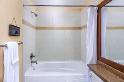 a bathroom with a white tub and a shower at Stonegate Resort Unit C105 in Kelowna