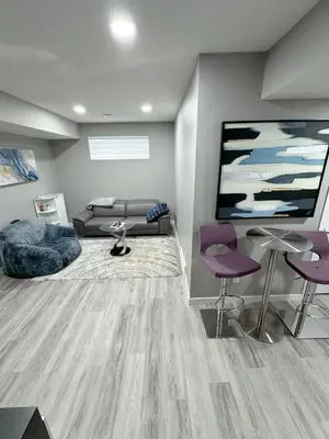 a living room with a couch and a flat screen tv at 2 Bedroom Basement Suite in Edmonton