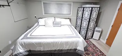 a bedroom with a large bed in a room at 1 block to Kelowna General Hospital 2 blocks to Beach 1km to OUC 1km to Downtown Kelowna 20min to YLW in Kelowna