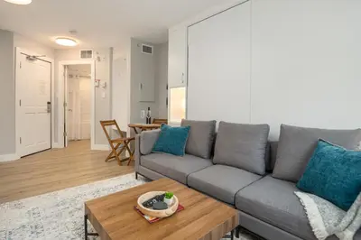 a living room with a gray couch and a table at KING Bed STUDIO in the Village in Whistler