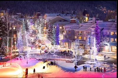 a city lit up with christmas trees and lights at Ideal Central Village Location! in Whistler