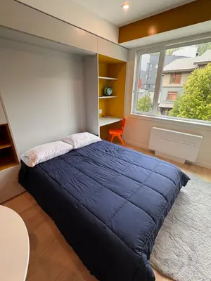 a bedroom with a blue bed and a window at Premium RED Mountain Lodging in Trail