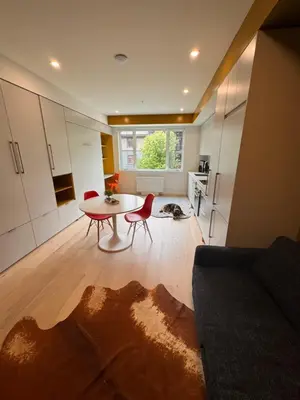 a living room with a table and chairs and a kitchen at Premium RED Mountain Lodging in Trail