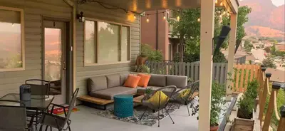 a patio with a couch on a house at Licensed 2-Bedroom Suite Eco-Friendly Solar Home in Kelowna