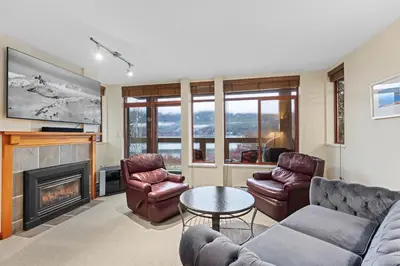 a living room with a couch and chairs and a fireplace at Nicklaus North - Clubhouse by Whistler Premier in Whistler
