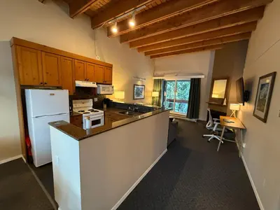 a kitchen with a white refrigerator and a counter top at Tantalus Lodge by Elevate Vacations in Whistler
