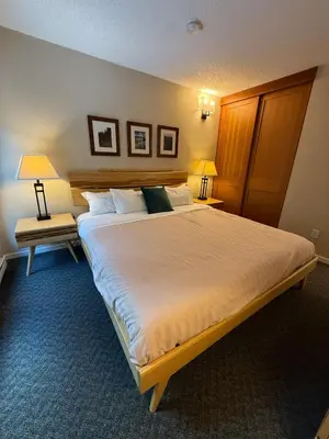 a large bed in a hotel room with two lamps at Tantalus Lodge by Elevate Vacations in Whistler