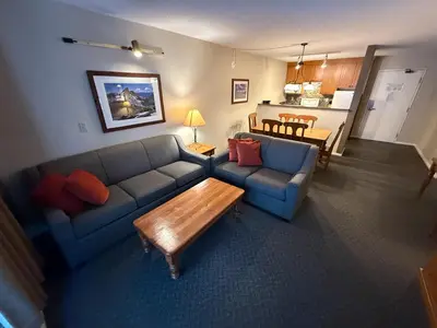 a living room with a couch and a table at Tantalus Lodge by Elevate Vacations in Whistler