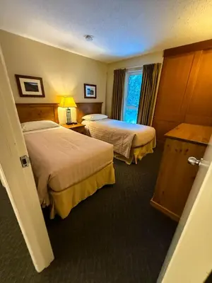 a hotel room with two beds and a window at Tantalus Lodge by Elevate Vacations in Whistler