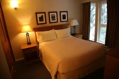 a hotel room with a bed and a window at Tantalus Lodge by Elevate Vacations in Whistler