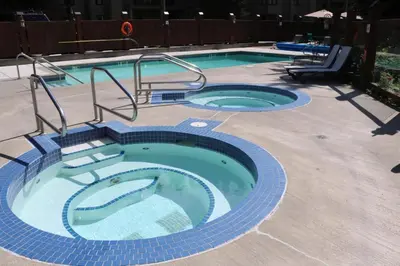 a large swimming pool with blue tile around it at Tantalus Lodge by Elevate Vacations in Whistler