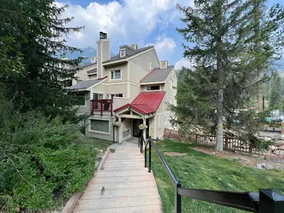 a large white house with a red roof at Toby Creek Lodge by StayIn in Panorama
