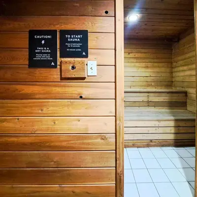 a sauna with two signs on a wall at Toby Creek Lodge by StayIn in Panorama