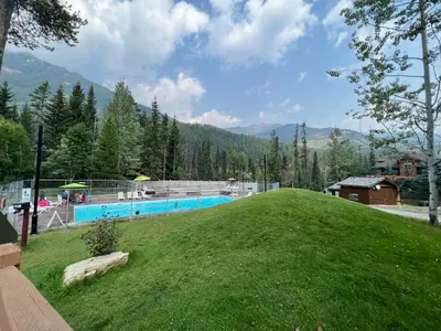 a large yard with a swimming pool on a hill at Toby Creek Lodge by StayIn in Panorama