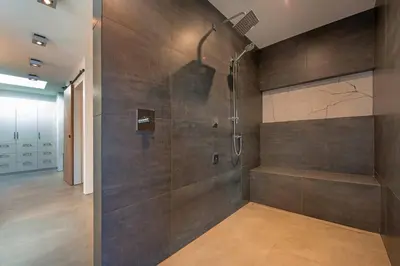 a bathroom with a shower with a glass door at Nest Luxury Modern Lake House in Penticton