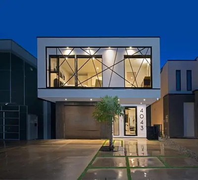 a house with a palm tree in a parking lot at Nest Luxury Modern Lake House in Penticton