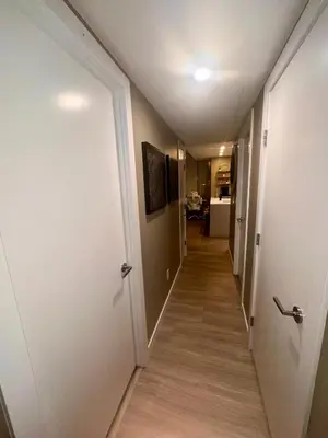 a hallway with a long hallway leading to a room at Century Park Condo Oasis in Edmonton